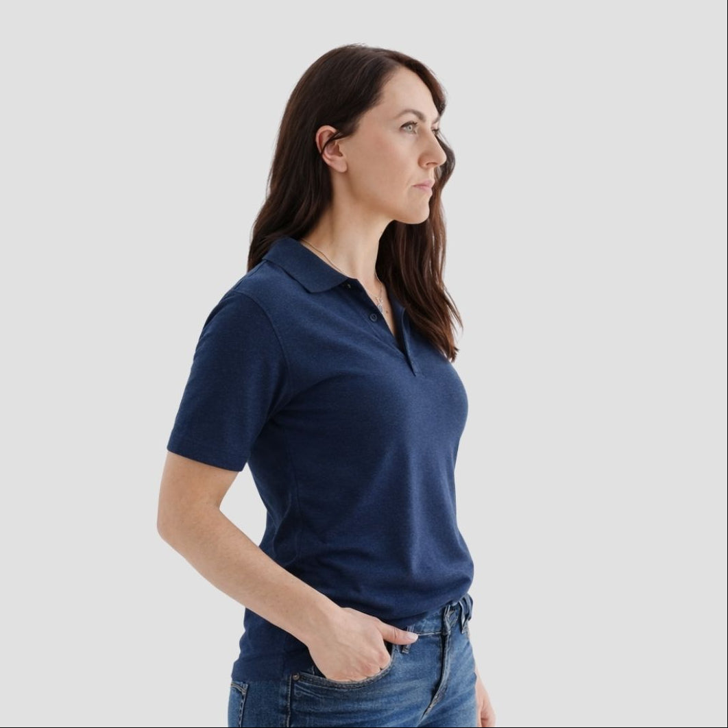 Woman wearing a navy blue polo shirt against a white background