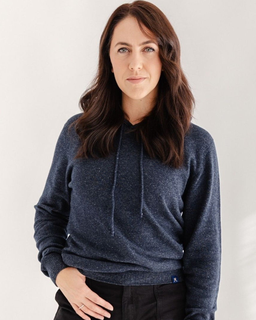 Woman wearing a blue hoodie against a white background