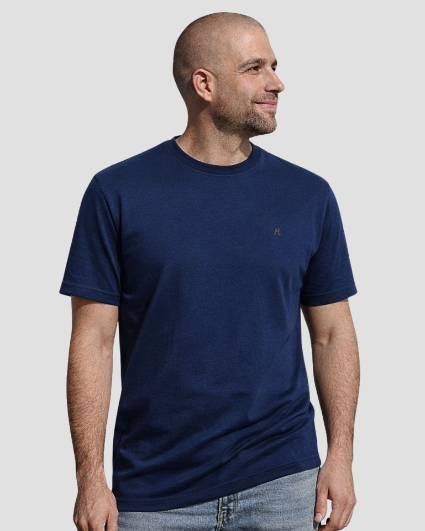 Man wearing a navy blue t-shirt on a light gray background