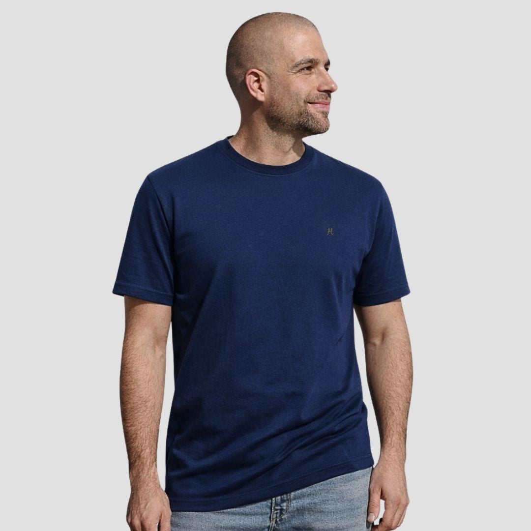 Man wearing a navy blue t-shirt on a light gray background