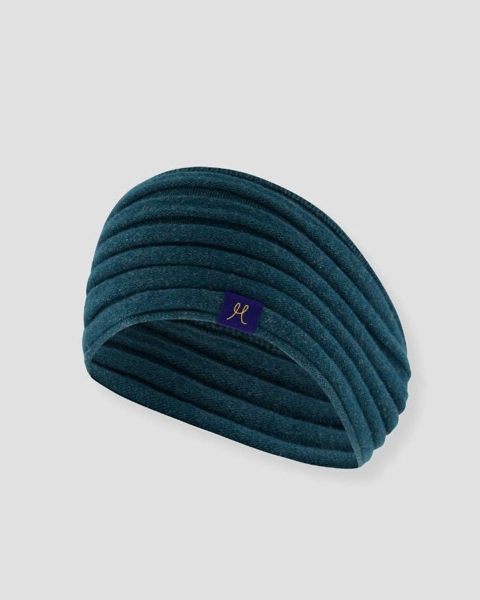 Teal headband with a logo on a light gray background