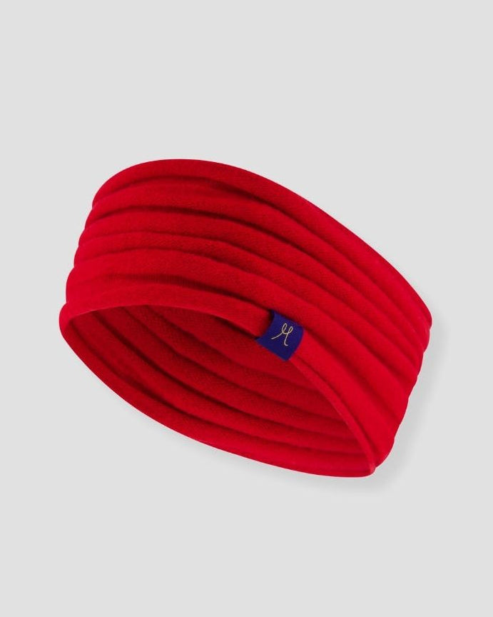 Red headband with a small logo on a light gray background