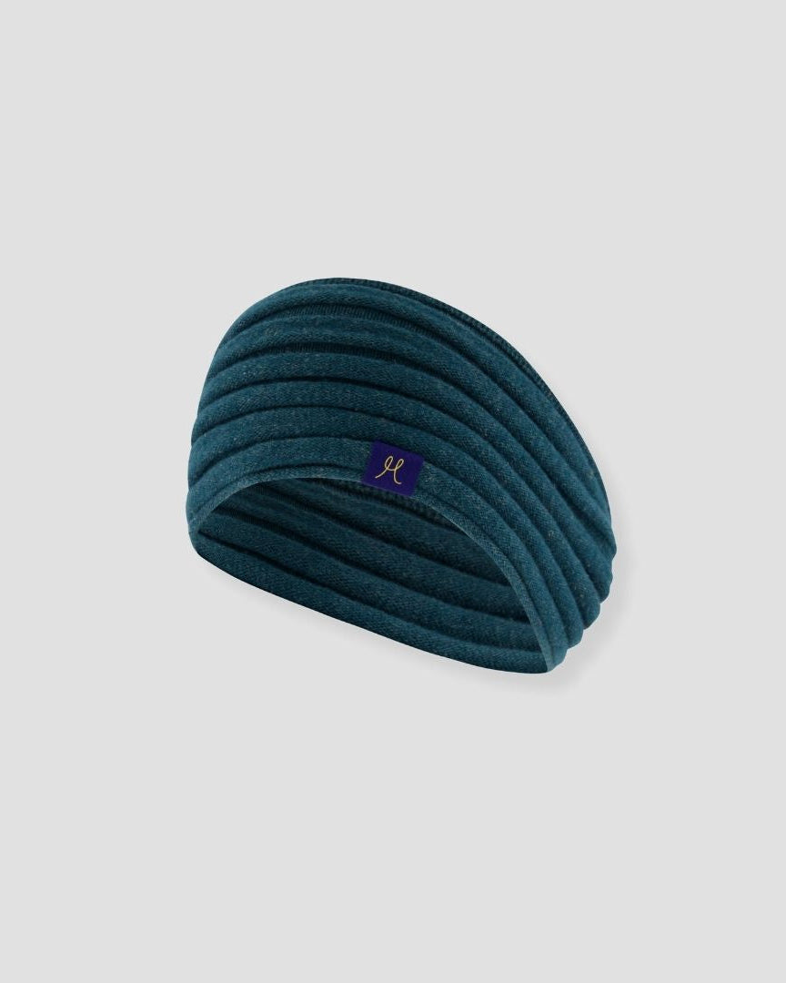 Teal headband with a logo on a light gray background