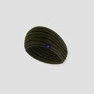 Green headband with a small logo on a light gray background