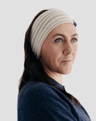 Woman wearing a natural headband against a light gray background