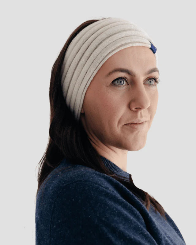Woman wearing a natural headband against a light gray background