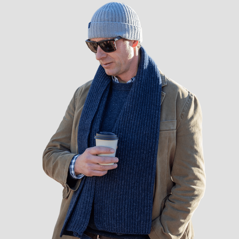 Middle aged man wearing checked shirt and navy blue quarter zip sweater