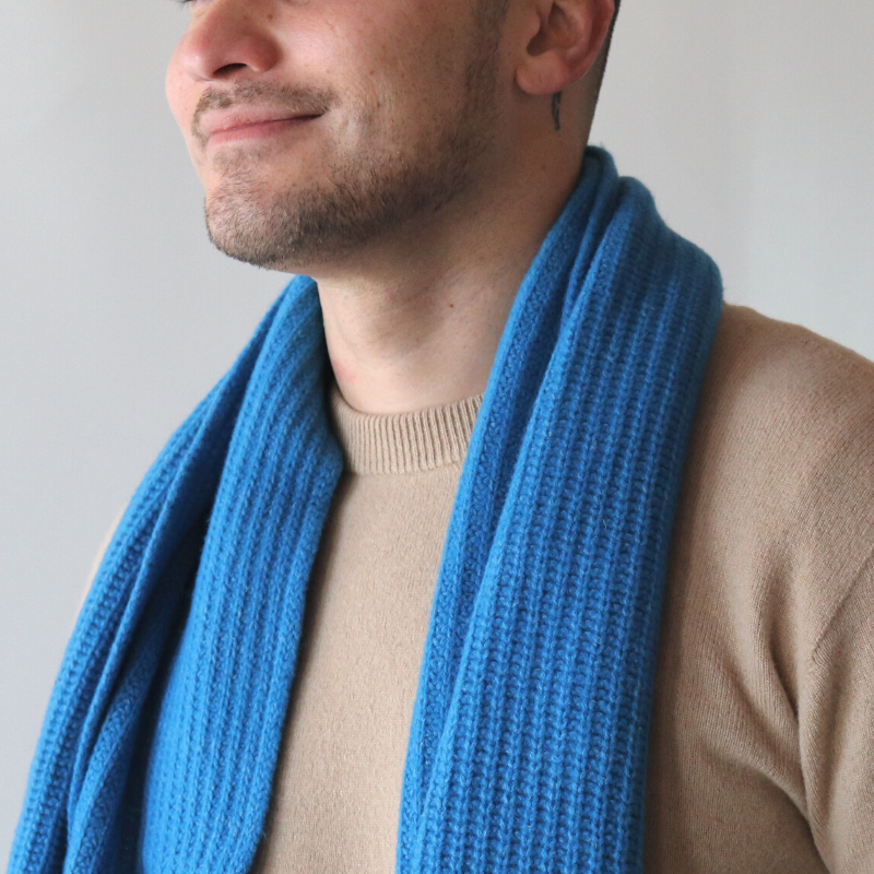 Middle aged man wearing bright blue scarf and beige hemp and merino jersey from Hemprino Knitwear.