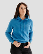 Woman wearing a blue hoodie against a plain background