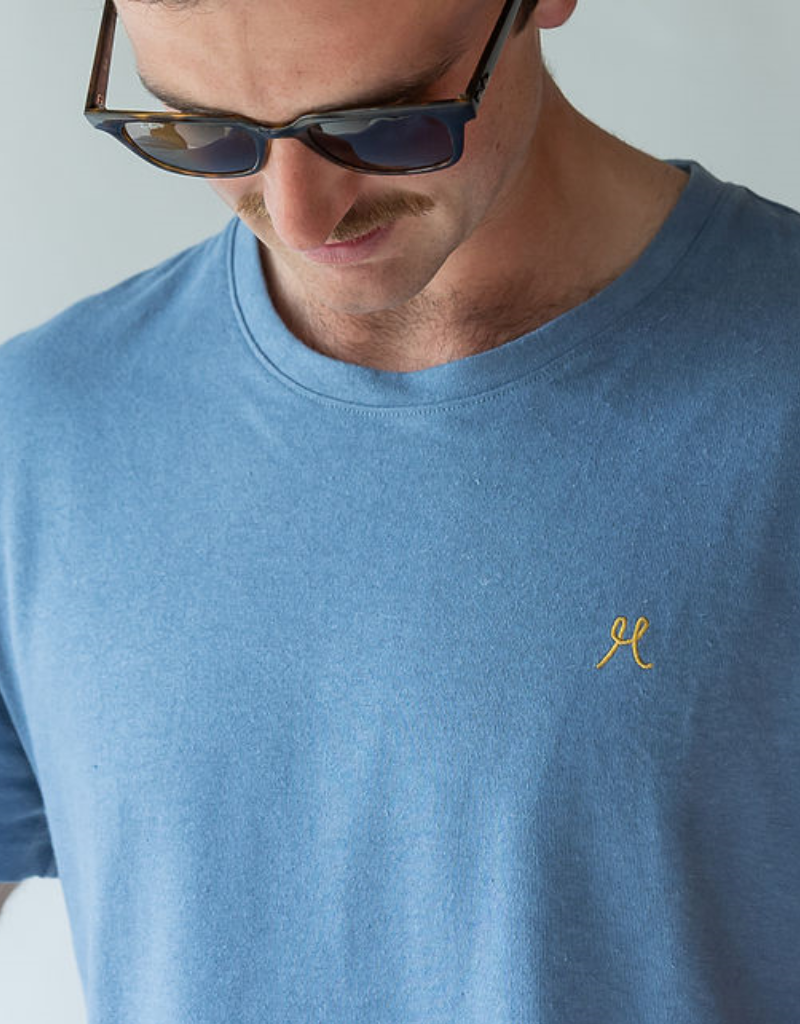 Man in light blue hemp tshirt wearing sunglasses. brand hemprino