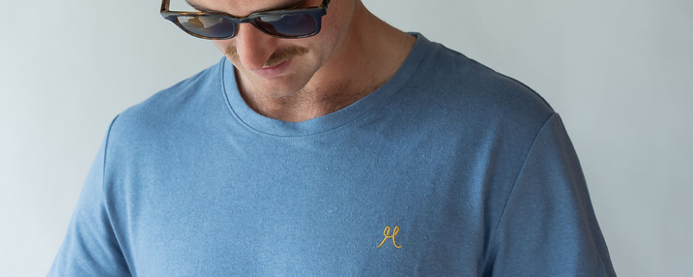 Man in light blue hemp tshirt wearing sunglasses. brand hemprino