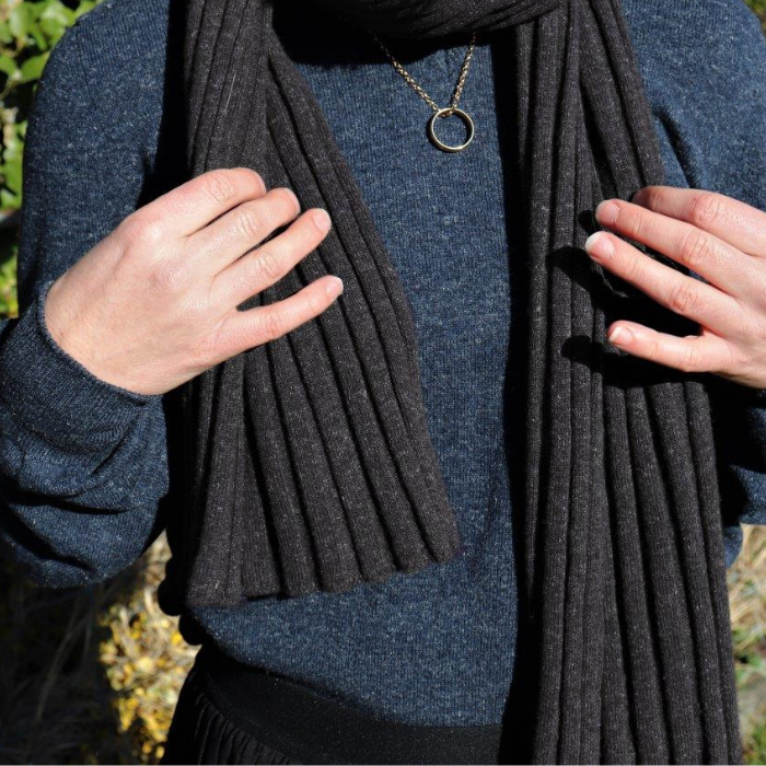 Lady in blue jumper wears charcoal ribbed scarf
