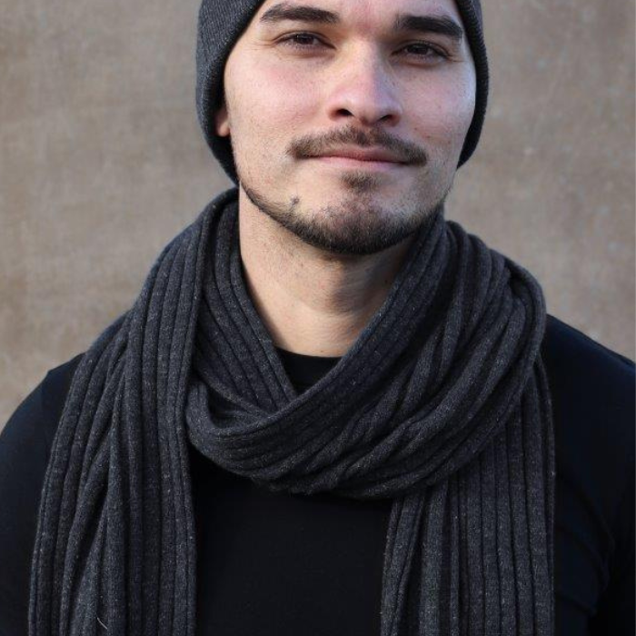 Man wearing charcoal grey beanie and neck scarf.