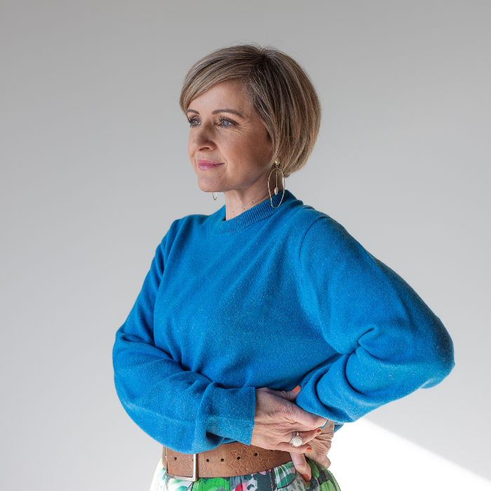 Middle aged blonde women with short hair wearing hemp and merino jersey sweater crew neck. Looking relaxed and happy. Hemprino