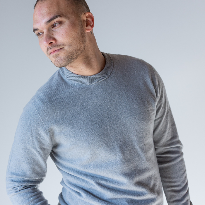 Man in grey crew neck jersey looking confident and comfortable. Hemprino jersey looks soft and smart.